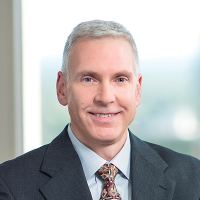 Headshot of Mark Ackerman smiling at the camera