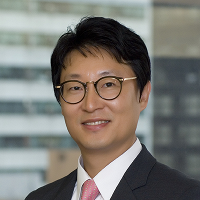 Headshot of Kenneth Shin smiling at the camera.