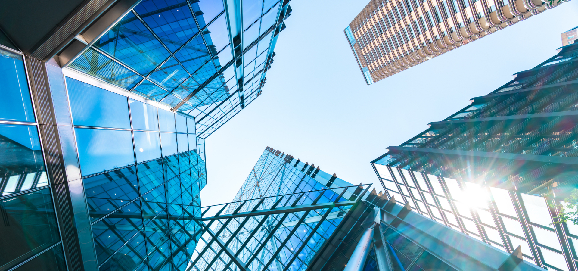 Looking up view of a group of tall buildings.